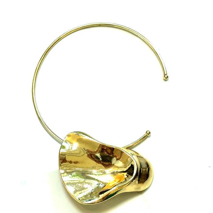 Gold-tone collar necklace with a large sculptural pendant and polished metallic shine.