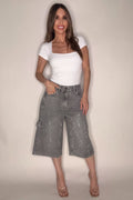 Gray denim Bermuda shorts with crystal stud embellishments, classic five-pocket styling, and a mid-length silhouette.