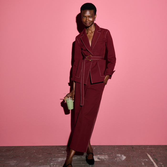 front image of a woman wearing the abby pant and grenville jacket in berry jam