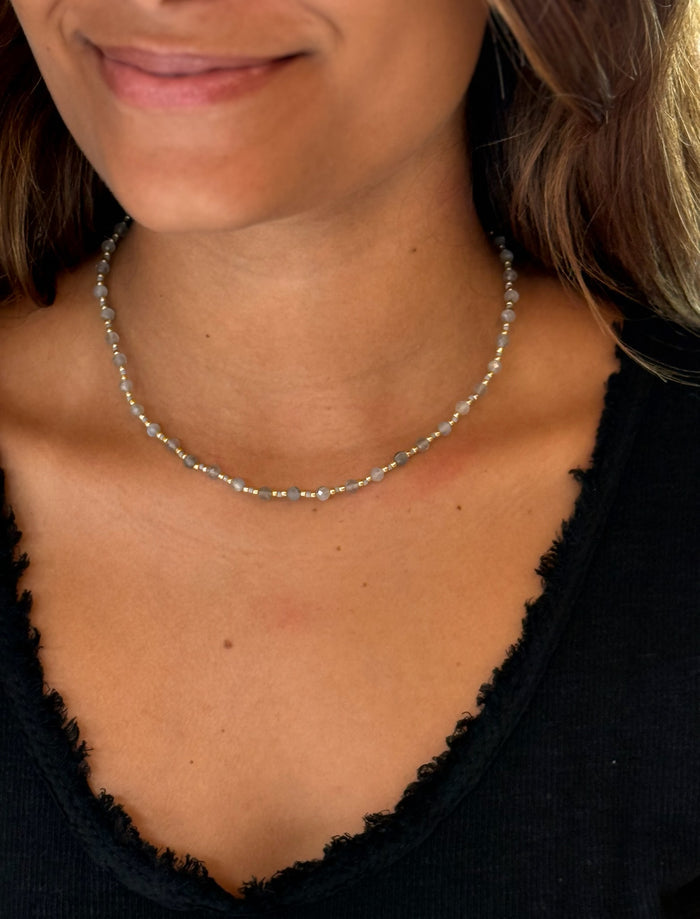 labradorite necklace shown paired with a black top on a model