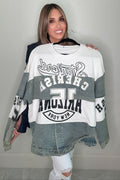 Half Denim Sporty Sweatshirt jacket with denim accent panels, athletic graphic print details, and a snap button hem.