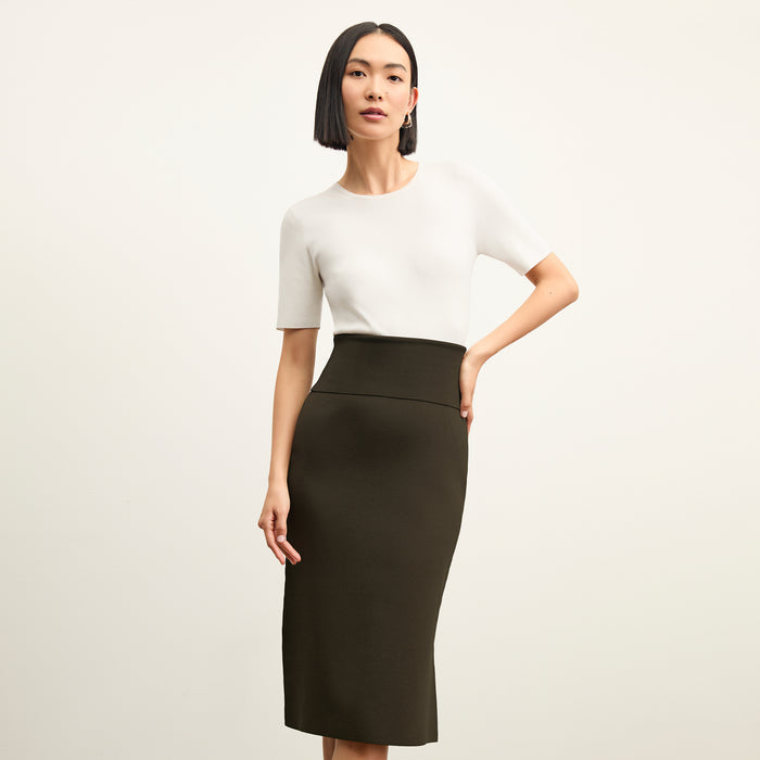 front image of a woman wearing the harlem skirt in dark elm