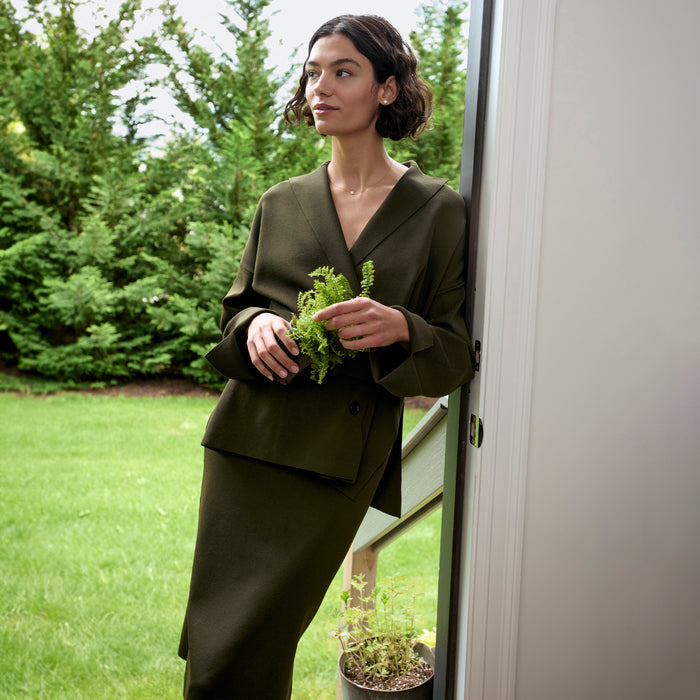 front image of a woman wearing the harlem skirt in dark elm