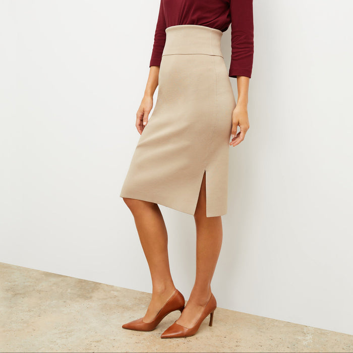Front image of a woman standing wearing the Harlem skirt in latte | Lead