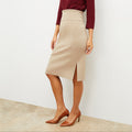 Front image of a woman standing wearing the Harlem skirt in latte | Lead