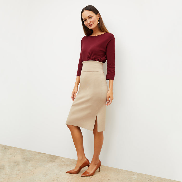 Front image of a woman standing wearing the Harlem skirt in latte