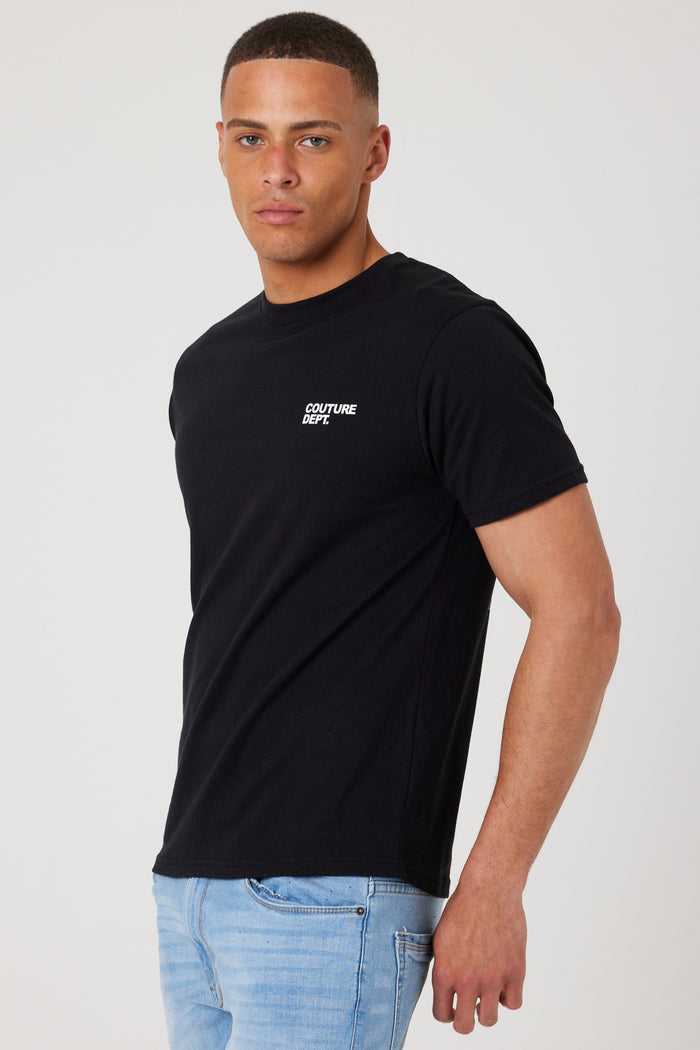 A man wears the Haydon Walk Regular Fit Cotton T-Shirt in black/white with Couture Dept on the chest and light blue jeans, standing against a plain light background for a casual yet polished style.