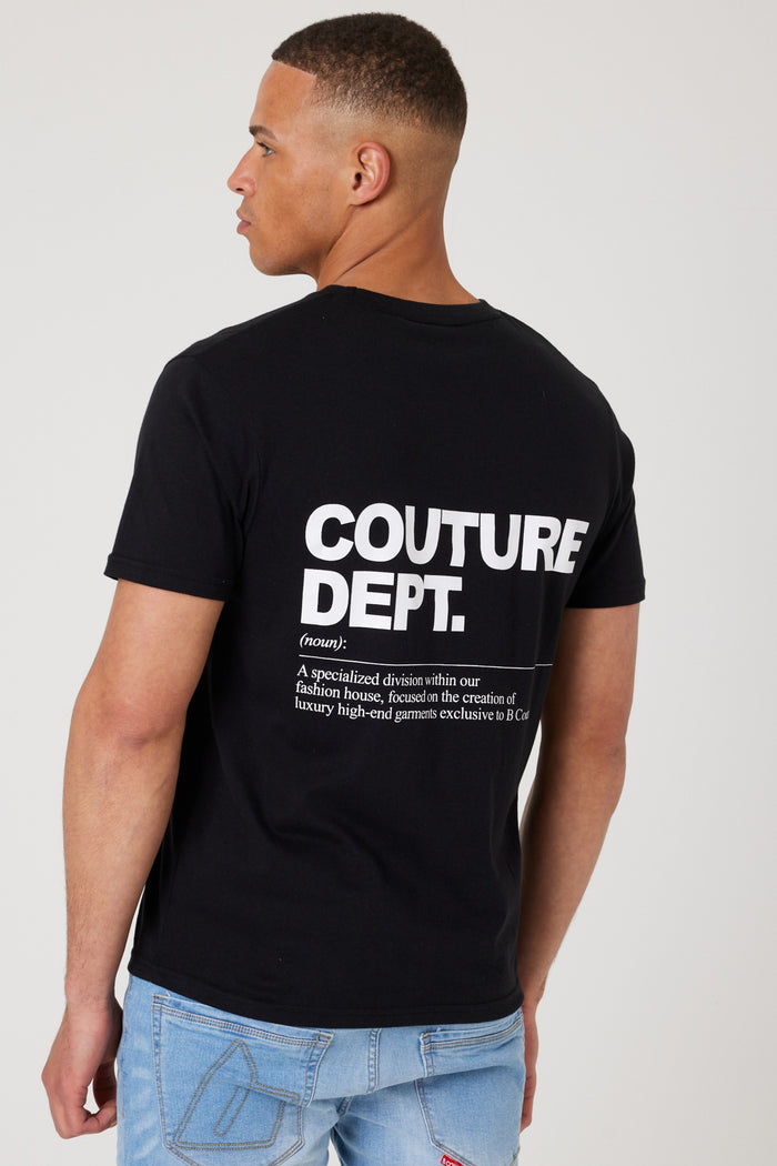 A man stands in light blue jeans, showcasing the Haydon Walk Regular Fit Cotton T-Shirt in black/white with COUTURE DEPT. and a definition printed on the back—a versatile wardrobe staple.