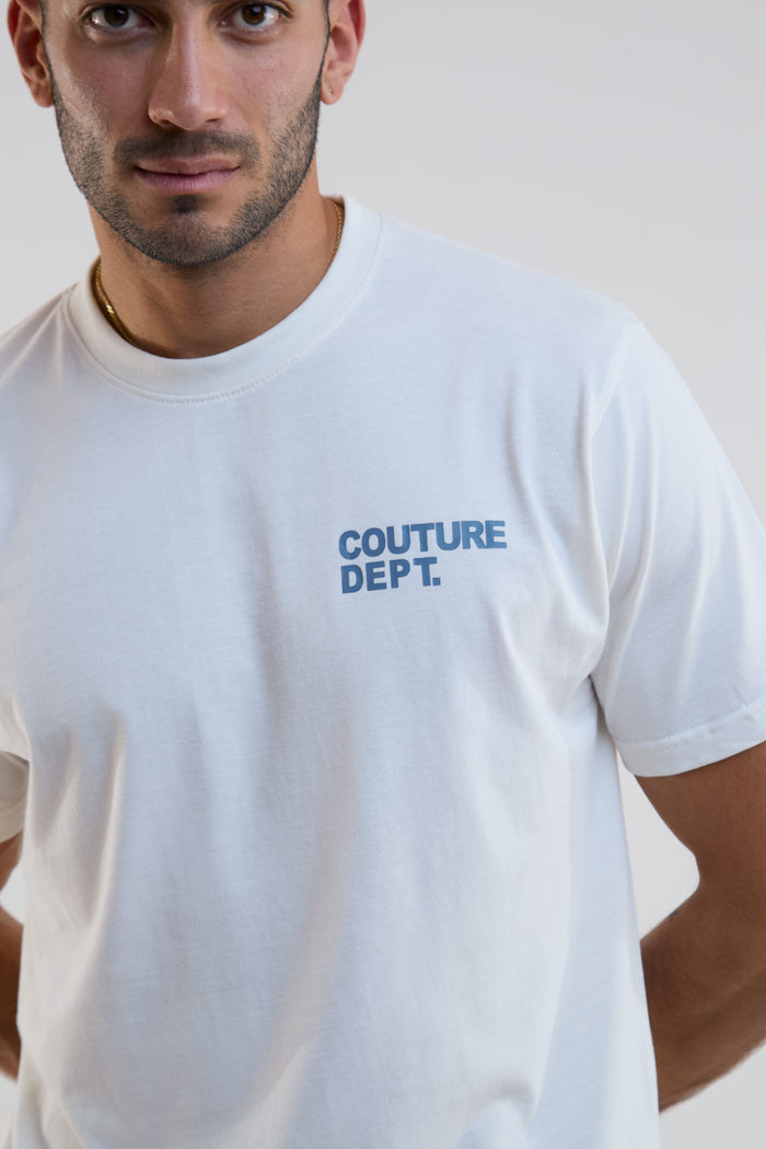 Man wearing a white t-shirt with 'COUTURE DEPT.' text on a plain background