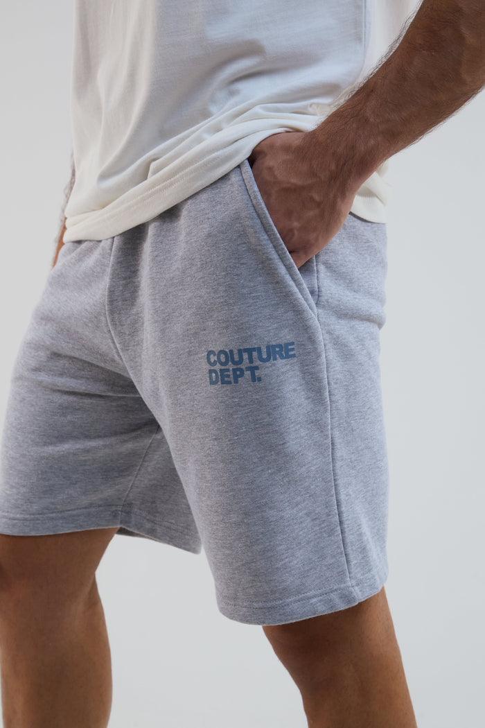 Gray shorts with 'Couture Dept.' text on a plain background