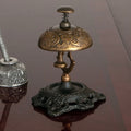 old fashioned hotel desk bell with spring loaded button, solid brass bell and iron base