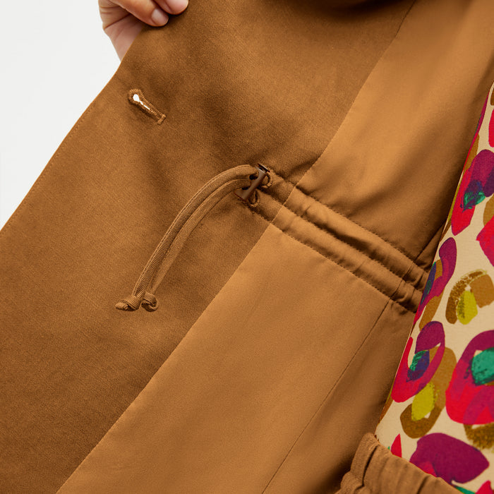 Front image of a woman wearing the Hyo Jacket in Acorn
