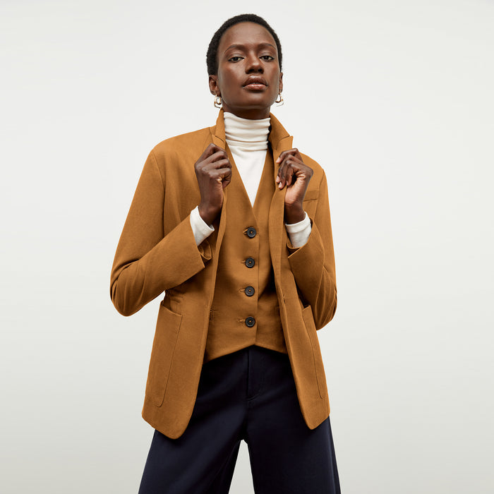 Front image of a woman wearing the Hyo Jacket in Acorn