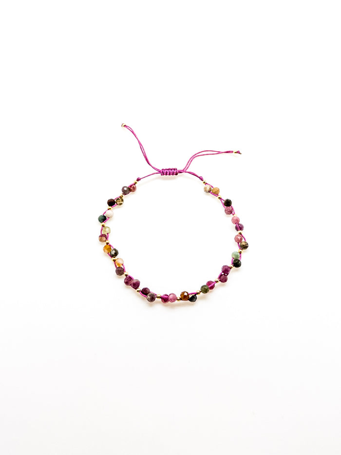 An adjustable tourmaline bracelet with a purple and green tones