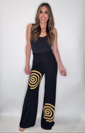 Black wide-leg Infinity Palazzo Pant with a flowing silhouette and bold gold swirl graphic detail.