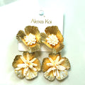 Ivory and gold oversized flower statement earrings with sculptural petal detailing and a warm metallic finish.