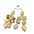 Ivory and hammered gold dangle earring with textured gold detail and a polished boutique jewelry look.