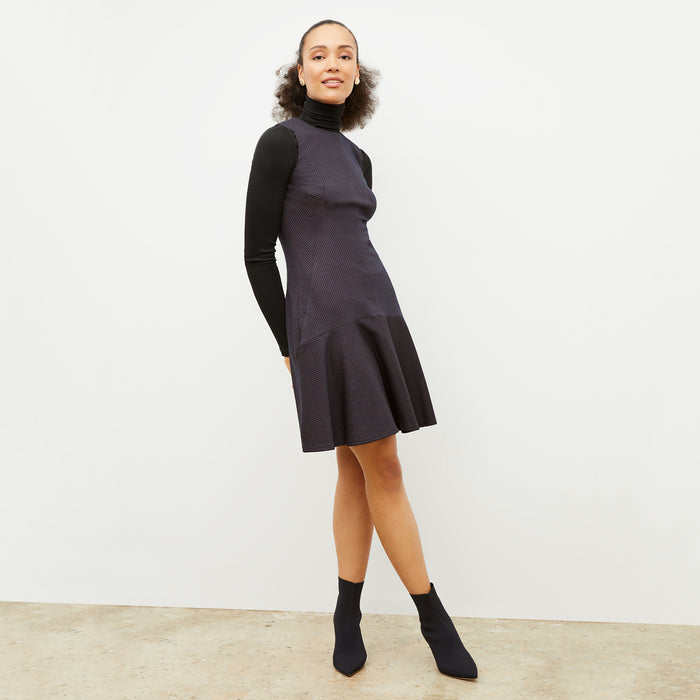 Front image of a woman wearing the jayde dress in navy multi