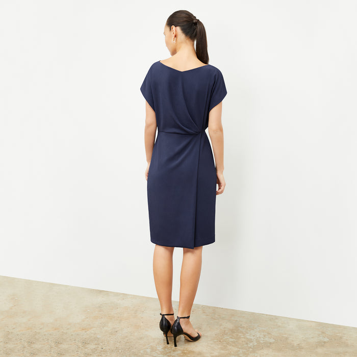 back image of a woman wearing the jillian dress in caspian blue