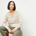 front image of a woman wearing the jo sweater in moonbeam | Lead