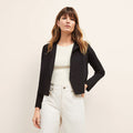 Front image of a woman sitting wearing the Jolie Jardigan in Black | Lead