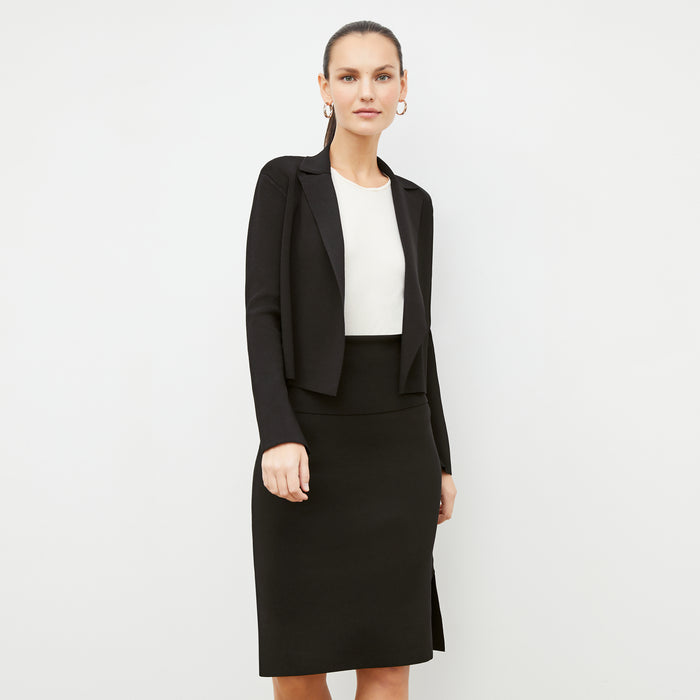 Front image of a woman standing wearing the Jolie Jardigan in Black