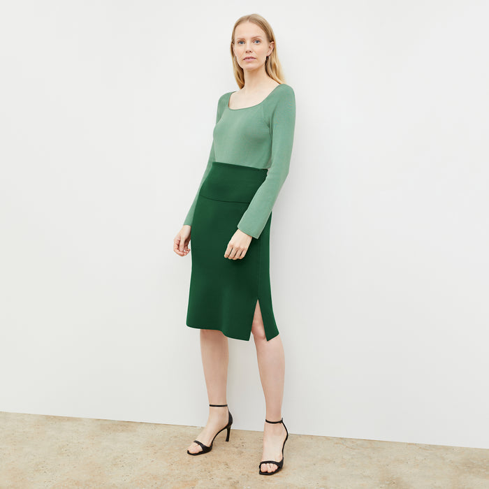 Front image of a woman wearing the joya top in spring green