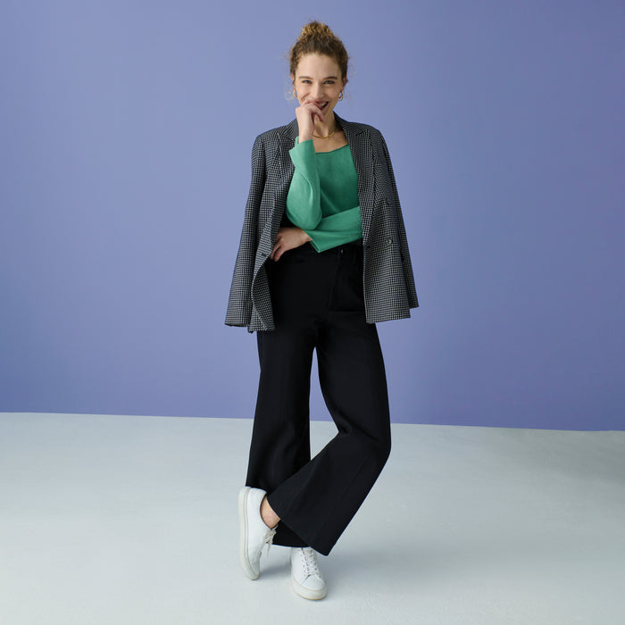 Front image of a woman wearing the joya top in spring green