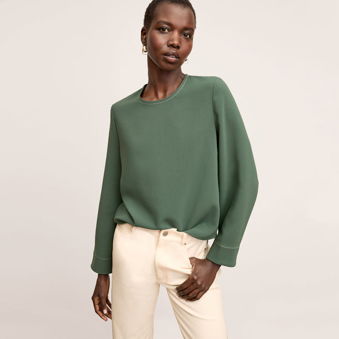 front image of a woman wearing the jules top in dusty pine | Lead
