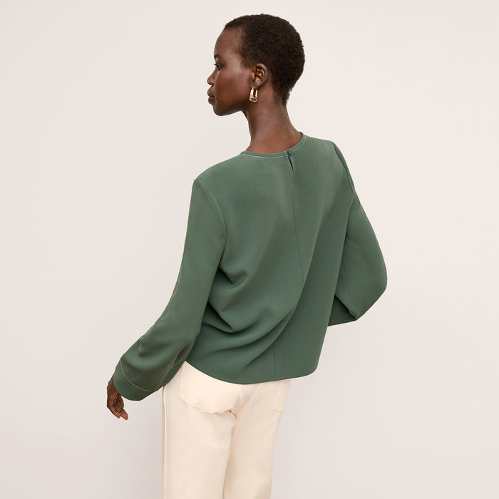 back image of a woman wearing the jules top in dusty pine