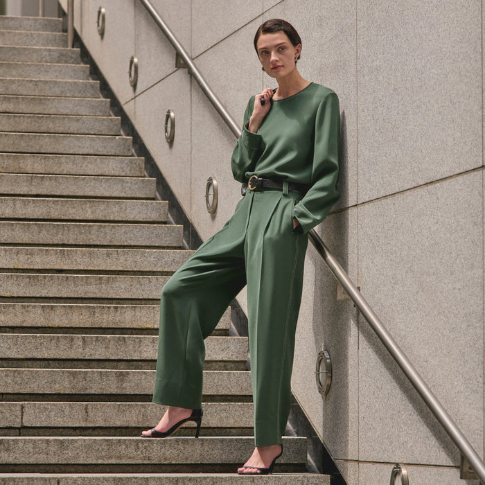 image of a woman wearing the jules top in dusty pine