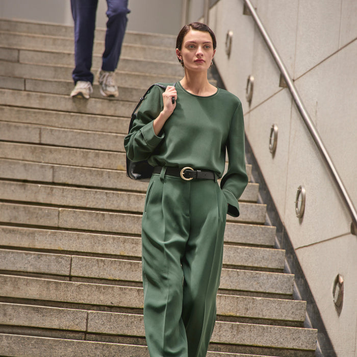 image of a woman wearing the jules top in dusty pine