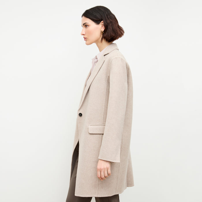 side image of a woman wearing the kasha coat in stone melange