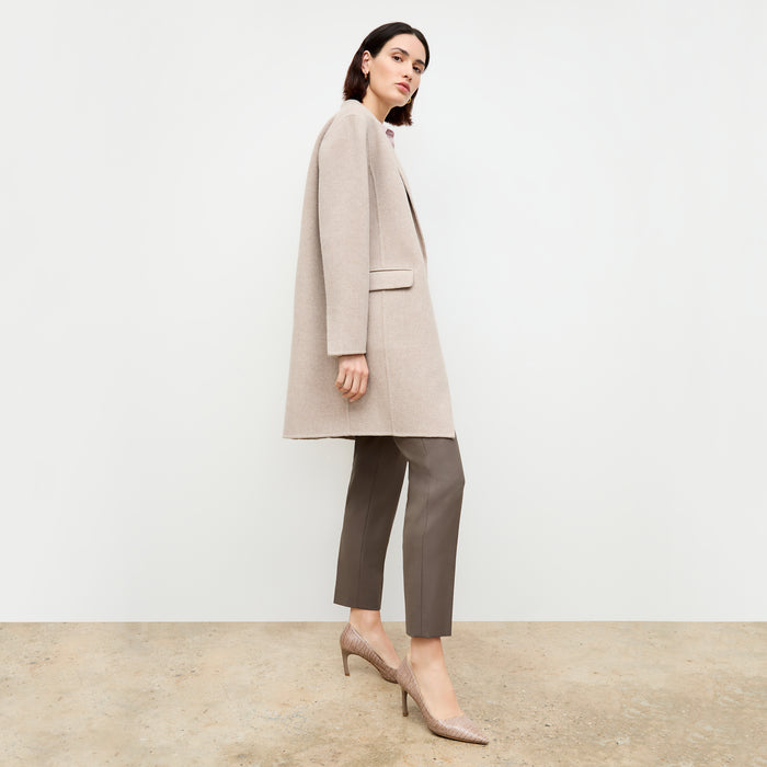 side image of a woman wearing the kasha coat in stone melange