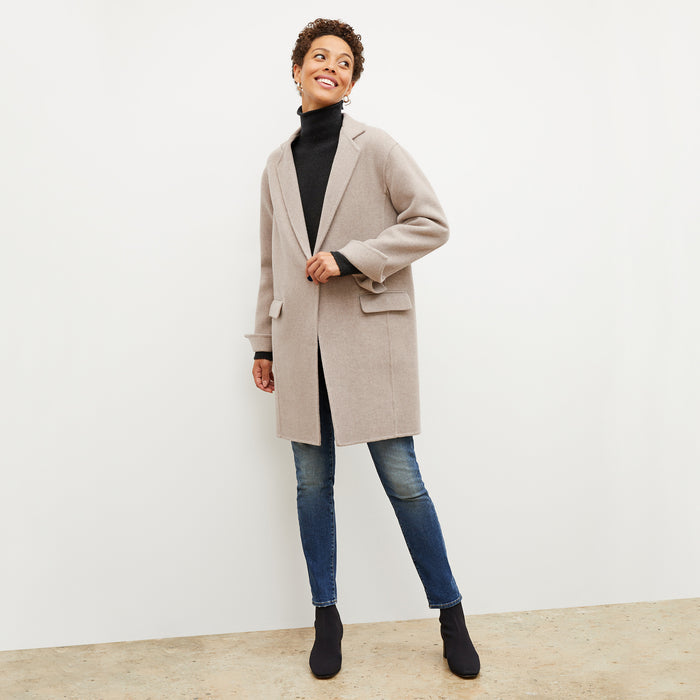 Front image of a woman wearing the kasha coat in stone melange