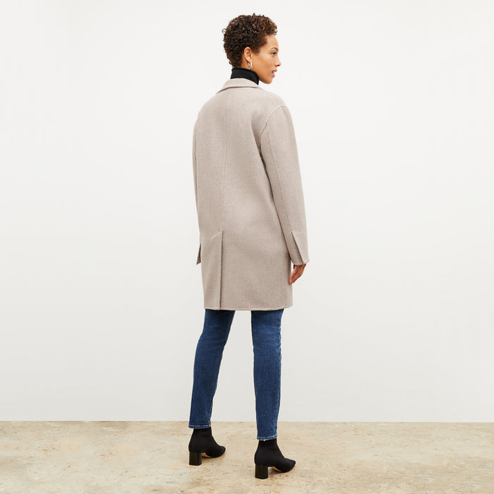 Back image of a woman wearing the kasha coat in stone melange