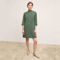 front image of a woman wearing the kinsley dress in dusty pine | Lead