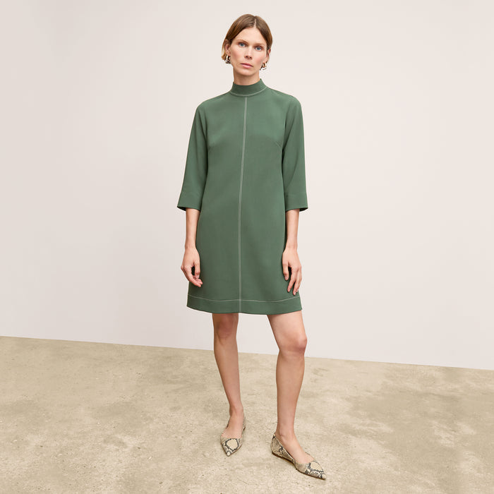 front image of a woman wearing the kinsley dress in dusty pine | Lead