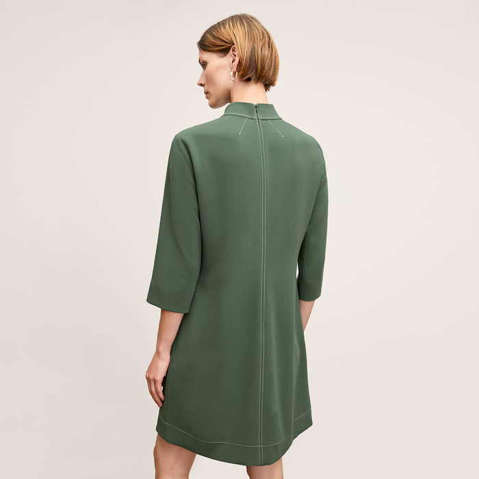 back image of a woman wearing the kinsley dress in dusty pine