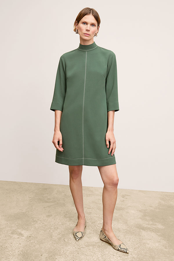 front image of a woman wearing the kinsley dress in dusty pine | Exclude | Grid