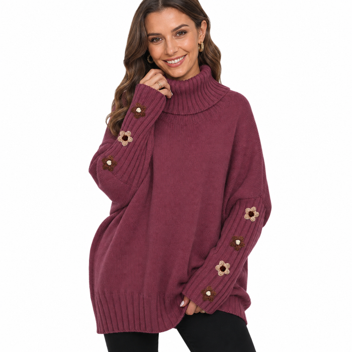 Wine red women's knit sweater close view highlighting the high neck, knit texture and floral sleeve details on white.