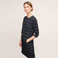 front image of a woman wearing the lancia dress in black/white | Lead