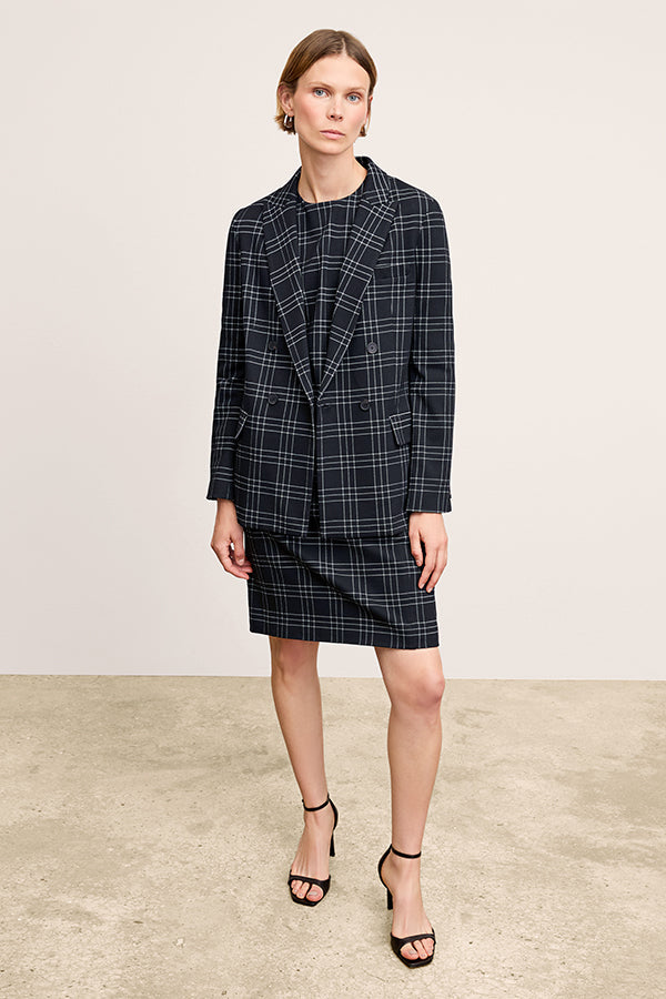 front image of a woman wearing the lancia dress in black/white | Exclude | Grid Hover