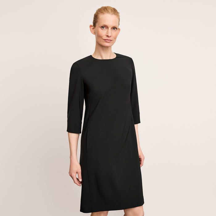 front image of a woman wearing the lancia dress in black | Lead