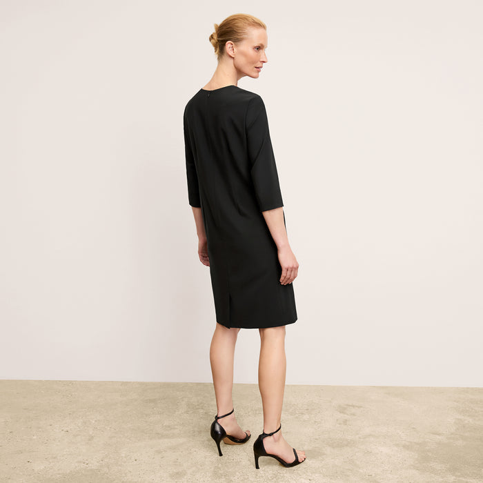 back image of a woman wearing the lancia dress in black