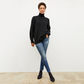 Front image of a woman wearing the lea sweater in black | Lead