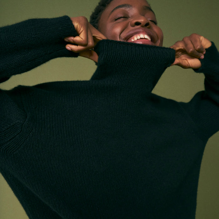 Front image of a woman wearing the lea sweater in black