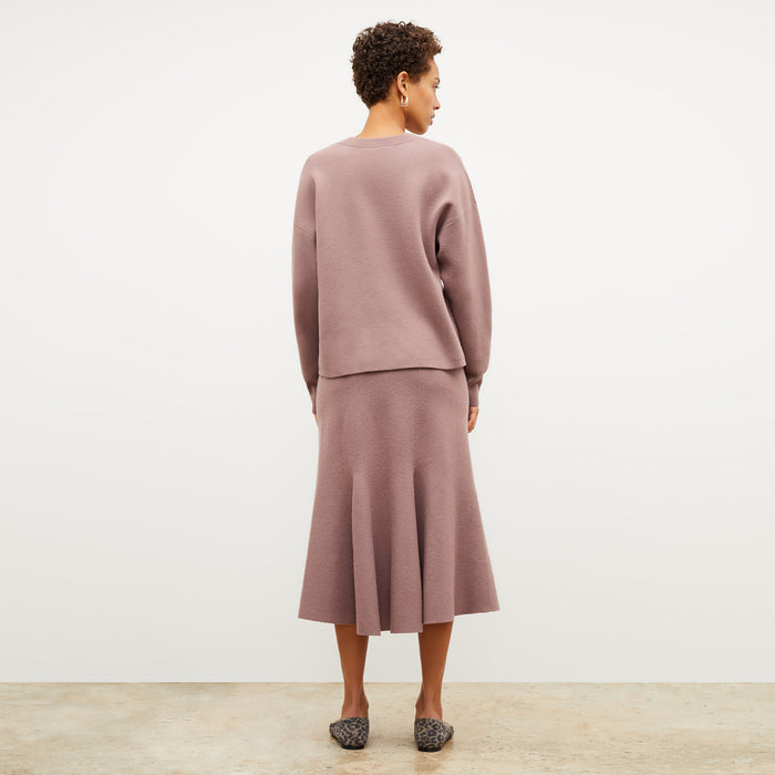 Back image of a woman wearing the leah skirt in rose taupe