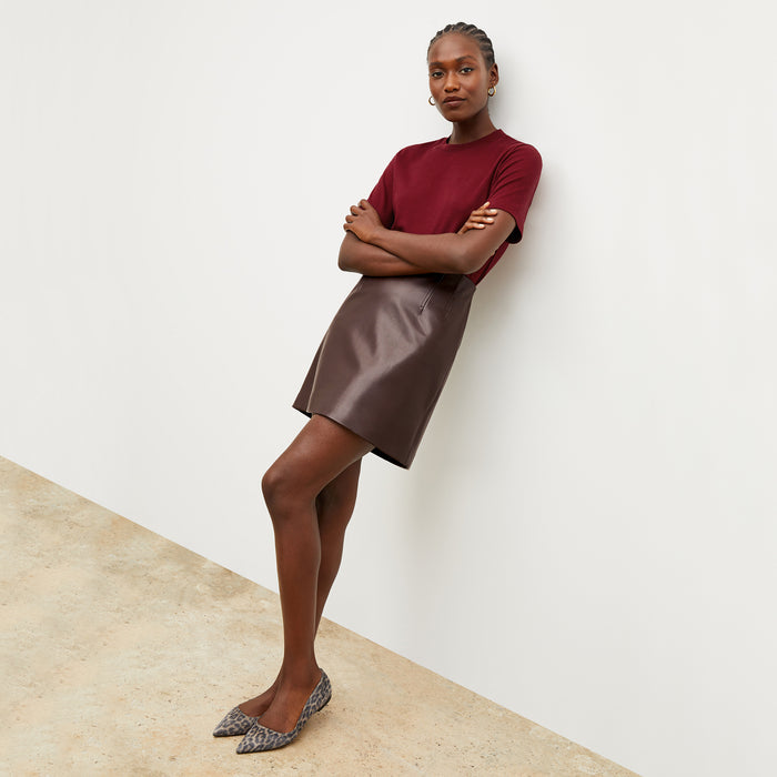 Front image of a woman wearing the leslie tshirt in maroon