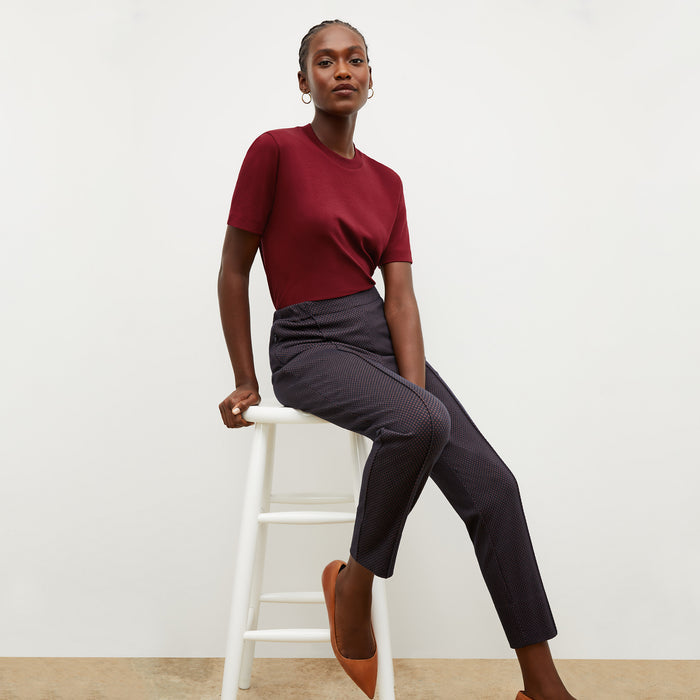 Front image of a woman wearing the leslie tshirt in maroon